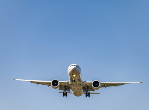 Low angle shot airplane flying closer daytime scaled